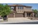 Inviting two-story home with a three-car garage and desert landscaping at 26062 W Potter Dr, Buckeye, AZ 85396