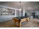 Open game room with pool table, tile floors, and easy access to kitchen at 26062 W Potter Dr, Buckeye, AZ 85396
