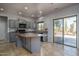 Bright kitchen with gray cabinets, center island, and backyard access at 26062 W Potter Dr, Buckeye, AZ 85396