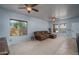 Cozy living room with neutral carpet, ceiling fans, and natural light at 26062 W Potter Dr, Buckeye, AZ 85396
