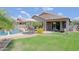 Inviting backyard features a well-manicured lawn, covered patio, and a refreshing pool, perfect for outdoor enjoyment at 26624 N 41St St, Cave Creek, AZ 85331