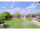 Lush green backyard with a pool, slide, and lounge chairs, perfect for outdoor relaxation and entertainment at 26624 N 41St St, Cave Creek, AZ 85331