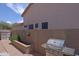 Cozy backyard featuring a built-in barbeque, brick pavers and desert landscaping against a privacy wall at 26624 N 41St St, Cave Creek, AZ 85331