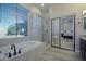 Bright bathroom featuring a glass shower, soaking tub and large window offering natural light at 26624 N 41St St, Cave Creek, AZ 85331