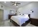 Bright bedroom featuring a ceiling fan, and an inviting dark wood bed frame and matching dressers at 26624 N 41St St, Cave Creek, AZ 85331