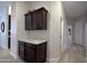 Hallway featuring dark wood cabinetry, granite countertops and decorative storage cabinets at 26624 N 41St St, Cave Creek, AZ 85331