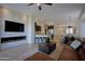 Inviting living room with a modern fireplace, entertainment center, and seamless flow to the kitchen at 26624 N 41St St, Cave Creek, AZ 85331