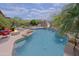 Resort-style backyard features a sparkling pool, water features, seating, and lush landscaping for ultimate relaxation at 26624 N 41St St, Cave Creek, AZ 85331