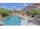 A stunning pool features a rock waterfall, a slide, and lounge area, providing a serene and luxurious retreat at 26624 N 41St St, Cave Creek, AZ 85331