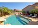Beautiful pool with slide, rock features, and a cozy fire pit lounge area at 26624 N 41St St, Cave Creek, AZ 85331