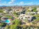 Aerial view showcases the house, pool, and mountain views in a private desert community at 28990 N White Feather Ln # 185, Scottsdale, AZ 85262