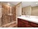Modern bathroom featuring a walk-in shower with tile and a vanity with white countertops at 28990 N White Feather Ln # 185, Scottsdale, AZ 85262