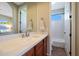 This modern bathroom features wood cabinets, stone countertop, and a large mirror at 28990 N White Feather Ln # 185, Scottsdale, AZ 85262