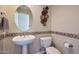 Elegant powder room with a pedestal sink, decorative mirror, and stylish wall accents at 28990 N White Feather Ln # 185, Scottsdale, AZ 85262