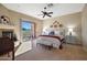 Relaxing bedroom with balcony access, a fireplace, and Southwestern decor at 28990 N White Feather Ln # 185, Scottsdale, AZ 85262
