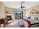 Bright bedroom featuring a cozy fireplace and sliding doors leading to a private balcony with desert views at 28990 N White Feather Ln # 185, Scottsdale, AZ 85262