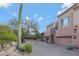 Exterior of home featuring beautiful desert landscaping, stone accents, and 3-car garage at 28990 N White Feather Ln # 185, Scottsdale, AZ 85262