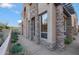 Desert home featuring beautiful stone details, a private sidewalk and well-manicured landscaping at 28990 N White Feather Ln # 185, Scottsdale, AZ 85262