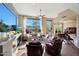 Bright living room featuring a fireplace, large windows, comfortable seating, and serene views at 28990 N White Feather Ln # 185, Scottsdale, AZ 85262