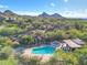 Aerial view of a community pool, mountains, and scenic desert landscaping at 28990 N White Feather Ln # 185, Scottsdale, AZ 85262