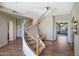 Elegant curved staircase with decorative iron railings and neutral carpeting at 28990 N White Feather Ln # 185, Scottsdale, AZ 85262