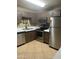 Modern kitchen featuring stainless steel appliances, sleek countertops, and tile flooring for easy maintenance at 30 E Brown Rd # 2065, Mesa, AZ 85201