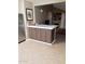 Stylish kitchen featuring a breakfast bar, ample cabinet space, and stainless steel refrigerator at 30 E Brown Rd # 2065, Mesa, AZ 85201