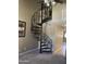 Interior shot showcasing a black, spiral staircase with decorative metalwork adding a unique architectural detail to the home at 30 E Brown Rd # 2065, Mesa, AZ 85201