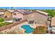 Aerial view showcasing a sparkling pool, covered patio, and well-kept desert landscaping in the backyard at 30032 N Desert Willow Blvd, San Tan Valley, AZ 85143