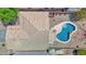 Aerial view of a home's backyard with a sparkling pool, patio area, and well-maintained desert landscaping at 30032 N Desert Willow Blvd, San Tan Valley, AZ 85143