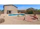 Backyard featuring a pool, desert landscaping, and a brick patio at 30032 N Desert Willow Blvd, San Tan Valley, AZ 85143