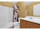 Bathroom featuring a tub and shower combination and a vanity with wood cabinets at 30032 N Desert Willow Blvd, San Tan Valley, AZ 85143