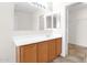 Bathroom with wood vanity, sink, and large mirror at 30032 N Desert Willow Blvd, San Tan Valley, AZ 85143
