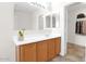 Bathroom with a spacious vanity area, ample lighting, and a convenient walk-in closet at 30032 N Desert Willow Blvd, San Tan Valley, AZ 85143