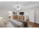 A staged bedroom features a wood bed frame, nightstands, and dresser with decorative lighting at 30032 N Desert Willow Blvd, San Tan Valley, AZ 85143