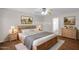 Cozy staged bedroom features a wood bed frame, nightstands, and a dresser at 30032 N Desert Willow Blvd, San Tan Valley, AZ 85143