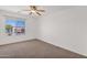 Bright bedroom with neutral carpet and a window offering neighborhood views at 30032 N Desert Willow Blvd, San Tan Valley, AZ 85143