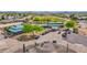 Aerial view of the clubhouse and golf carts with covered seating area and desert landscaping at 30032 N Desert Willow Blvd, San Tan Valley, AZ 85143