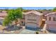 Beautiful two-story home with a tile roof, two-car garage, desert landscaping, and mature shade trees at 30032 N Desert Willow Blvd, San Tan Valley, AZ 85143