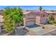 Attractive two-story home with desert landscaping, a two-car garage, and a charming tile roof at 30032 N Desert Willow Blvd, San Tan Valley, AZ 85143