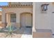 Inviting front porch with decorative door and desert landscaping, featuring address number at 30032 N Desert Willow Blvd, San Tan Valley, AZ 85143