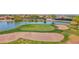 Lush, green golf course with sand trap, lake and waterfall and homes in the distance at 30032 N Desert Willow Blvd, San Tan Valley, AZ 85143