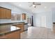 Well-lit kitchen featuring wood cabinets, tile flooring, and modern appliances at 30032 N Desert Willow Blvd, San Tan Valley, AZ 85143