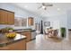 Bright kitchen featuring granite counters, stainless steel appliances, and adjacent breakfast nook with backyard access at 30032 N Desert Willow Blvd, San Tan Valley, AZ 85143