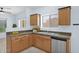 Well-lit kitchen with a stainless steel dishwasher and a view to the dining area at 30032 N Desert Willow Blvd, San Tan Valley, AZ 85143