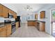 Modern kitchen featuring stainless steel appliances, wood cabinets, and tile flooring at 30032 N Desert Willow Blvd, San Tan Valley, AZ 85143