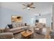 Inviting living room with a ceiling fan, comfortable seating, and large art piece creates a cozy atmosphere at 30032 N Desert Willow Blvd, San Tan Valley, AZ 85143