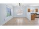 Bright living area featuring tile floors and multiple windows, adjacent to the kitchen at 30032 N Desert Willow Blvd, San Tan Valley, AZ 85143