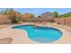 Inviting backyard pool area with a charming rock feature and desert landscaping at 30032 N Desert Willow Blvd, San Tan Valley, AZ 85143