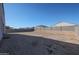 The home's backyard featuring a rock ground cover and a block wall for backyard privacy at 30560 W Weldon Ave, Buckeye, AZ 85396